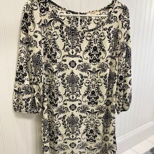 Mid length cream and black patterned dress.